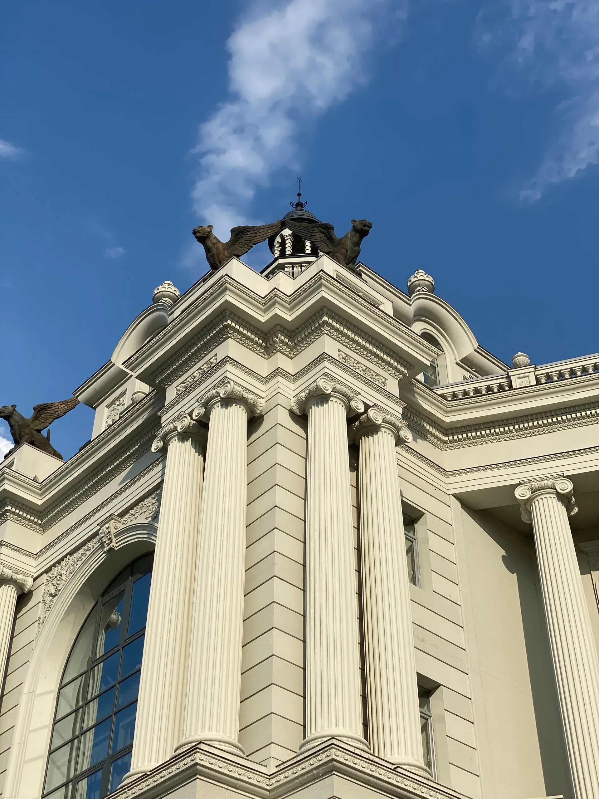 Neoclassical courthouse columns against a blue sky