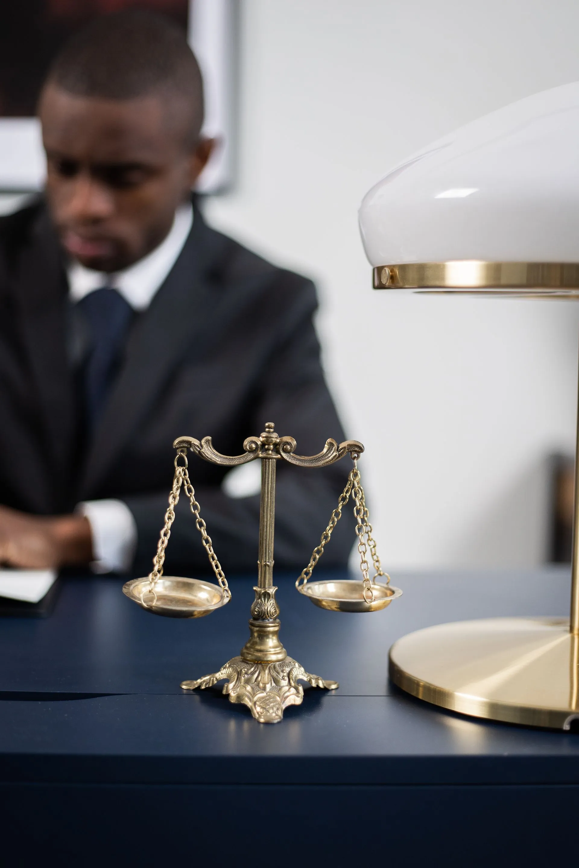 A brass scale of justice on an attorney's desk